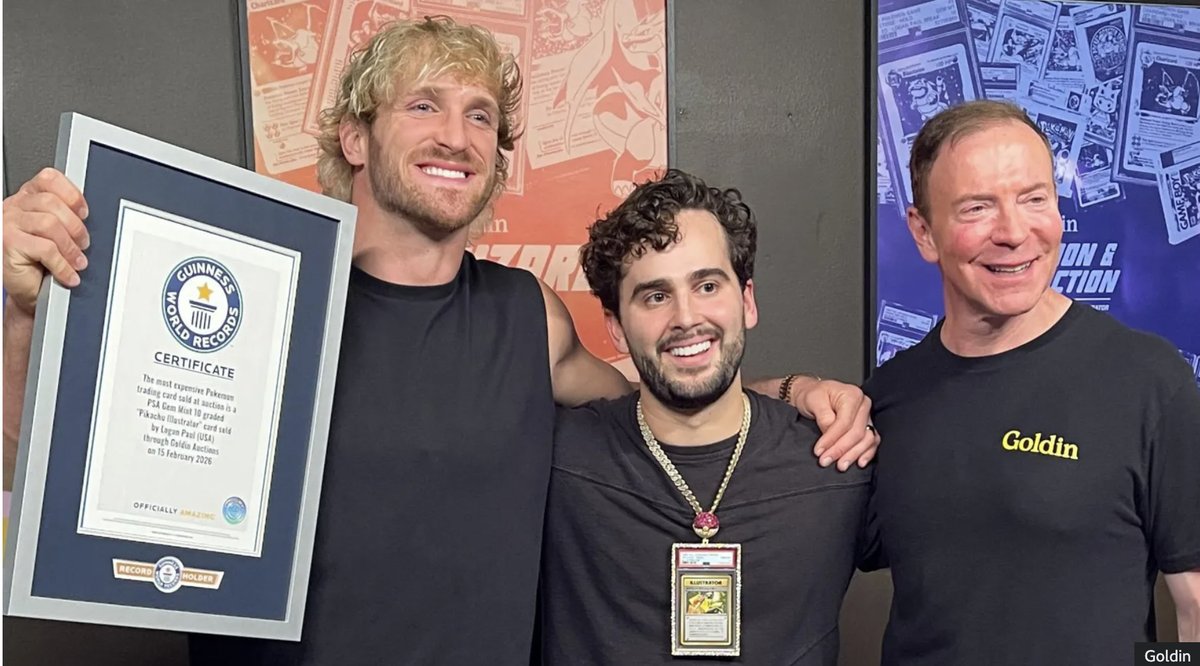 Logan Paul handing over the record-breaking Pikachu Illustrator card next to a Guinness World Records certificate